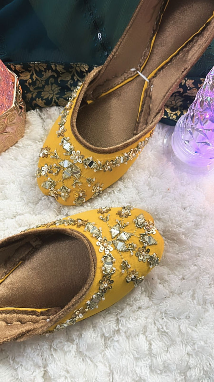 Traditional bridal outfit collection with intricately embroidered gharara, festive potli clutch, handcrafted khussa shoes, and jewelry for nikaah functions.