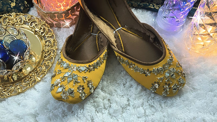 South Asian wedding wear collection including gharara pants, potli bag, khussa jutti, necklace, earrings, and bangles – perfect for Diwali parties.