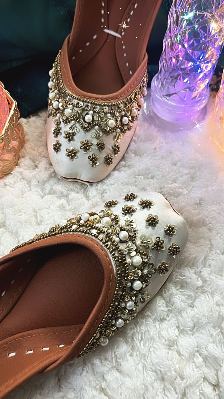 South Asian wedding wear collection including gharara pants, potli bag, khussa jutti, necklace, earrings, and bangles – perfect for Diwali parties.