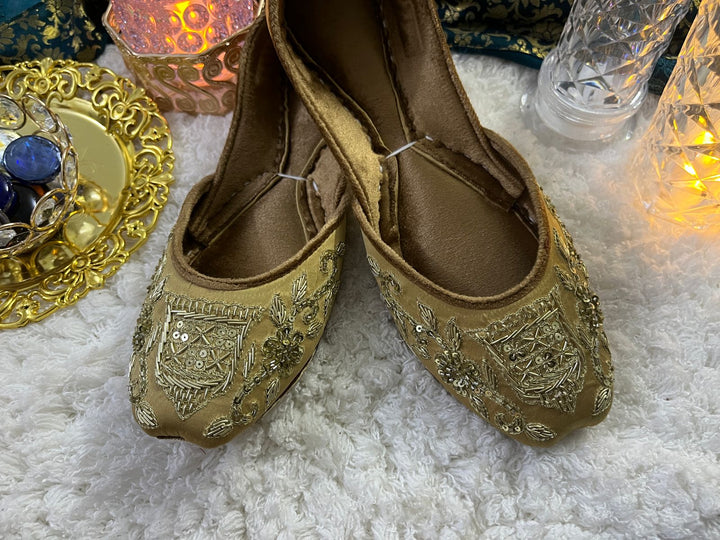 Traditional bridal outfit collection with intricately embroidered gharara, festive potli clutch, handcrafted khussa shoes, and jewelry for nikaah functions.
