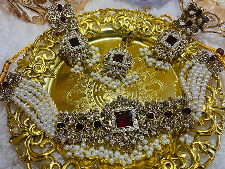 Luxury festive wear set featuring gharara, potli handbag, khussa shoes, and elegant jewelry for Diwali and wedding events.