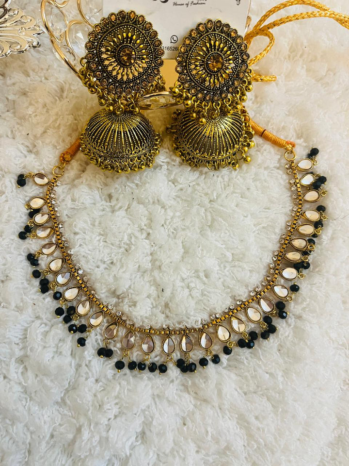 Traditional bridal outfit collection with intricately embroidered gharara, festive potli clutch, handcrafted khussa shoes, and jewelry for nikaah functions.
