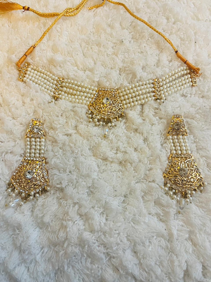 Naaz by Nazia bridal collection with 8 coordinated pieces: gharara outfit, dupatta, potli bag, khussa flats, and matching jewelry – ideal for mehndi.