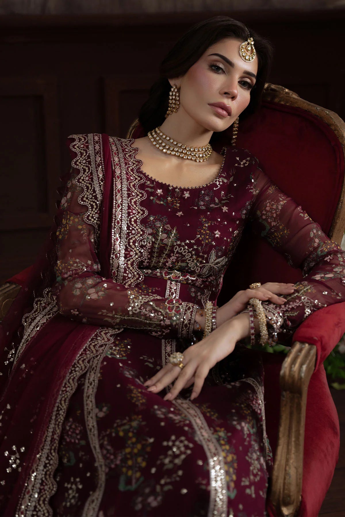 Model seated in Nureh Elanora NEL-72 showcasing sleeve and cuff embroidery details
