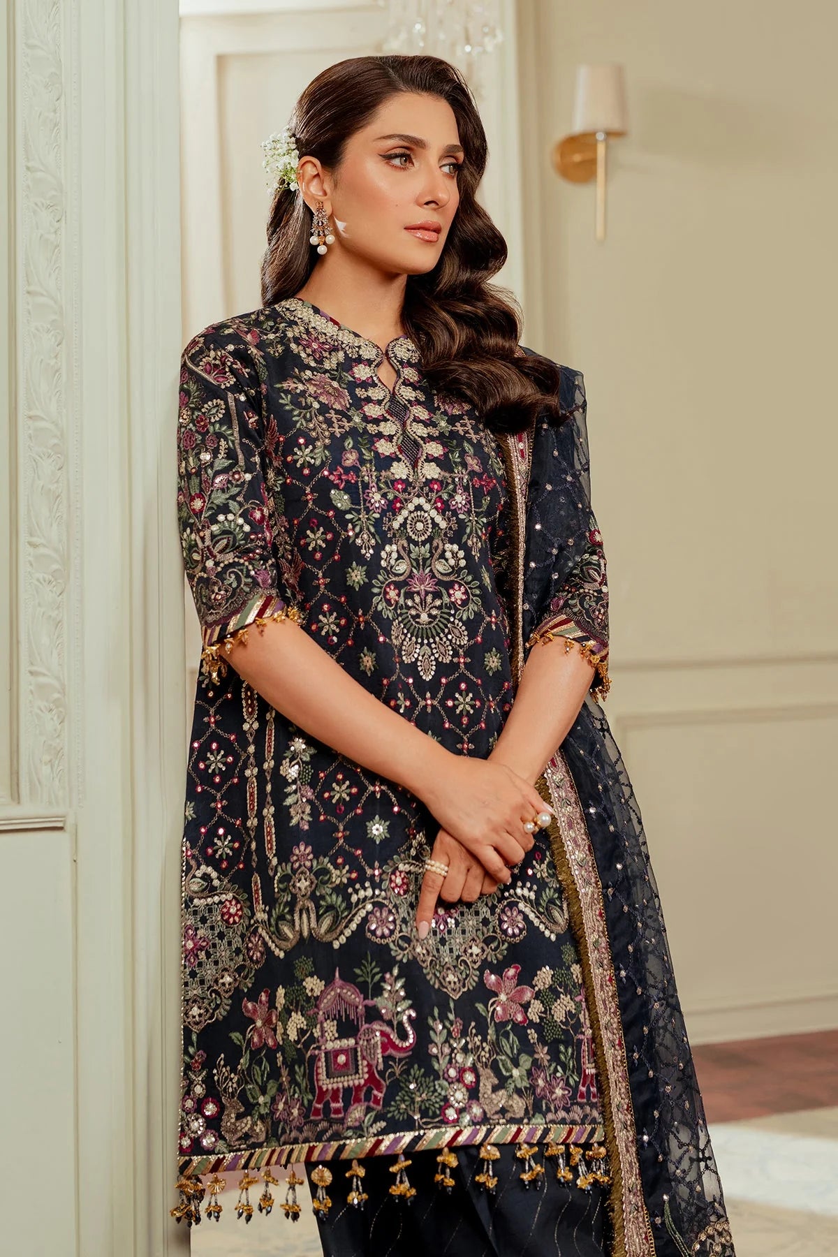 close up of stitched raw silk Pakistani formal outfit with embroidered dupatta and shalwar

