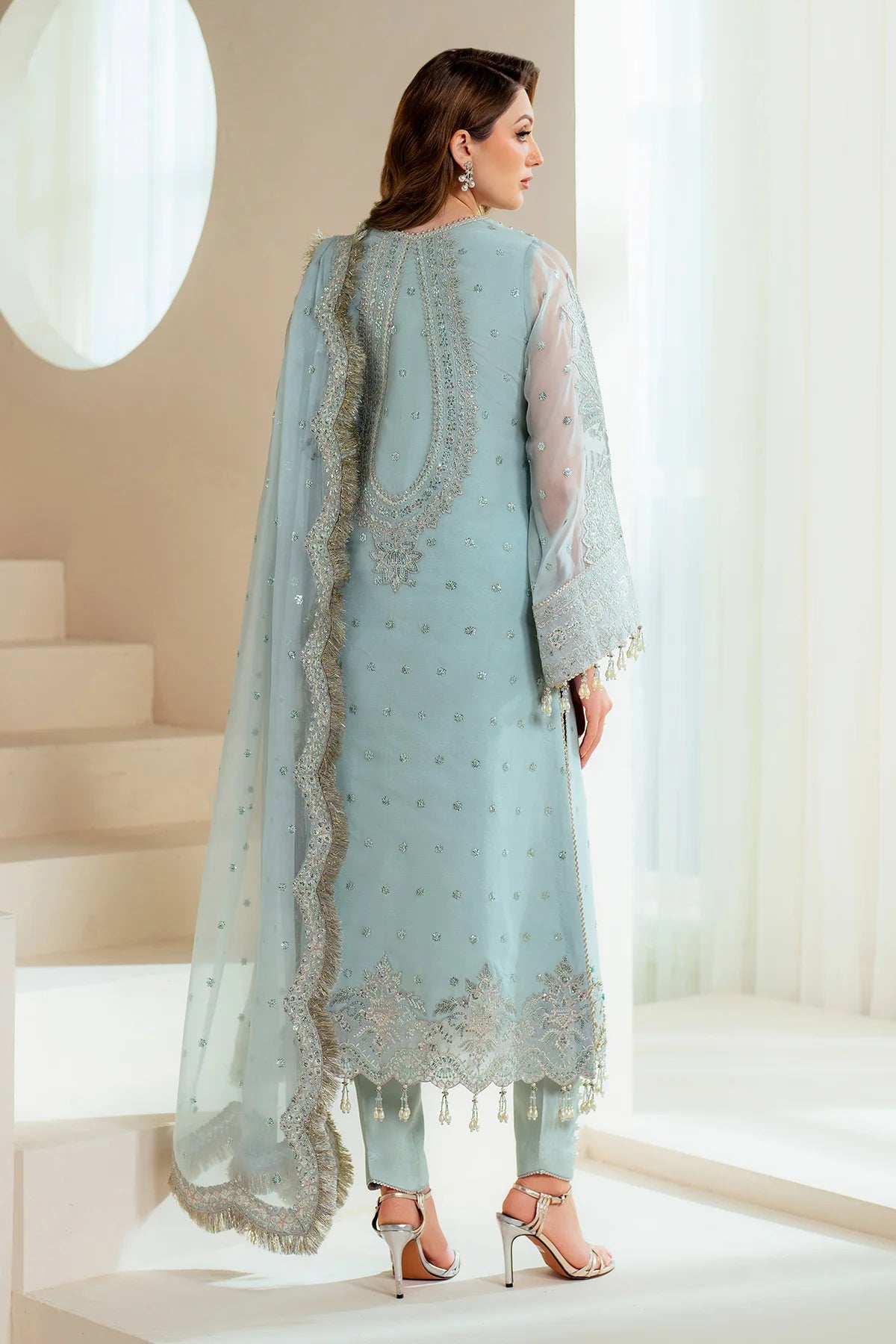 Close-up of Orla stitched neckline with aqua blue hand embellishments and sequin details