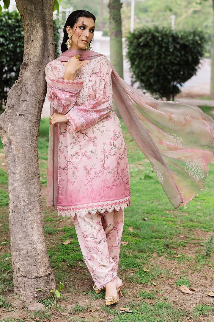 Model seated in Nureh lawn dress, highlighting fabric texture and elegance