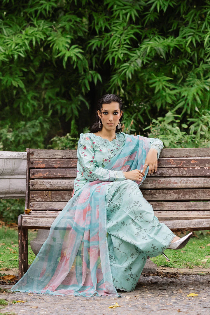 Model seated in Nureh lawn dress, highlighting fabric texture and elegance