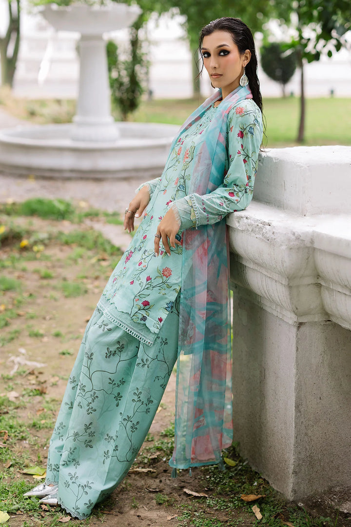 Side view of model showcasing Nureh designer lawn suit with elegant prints