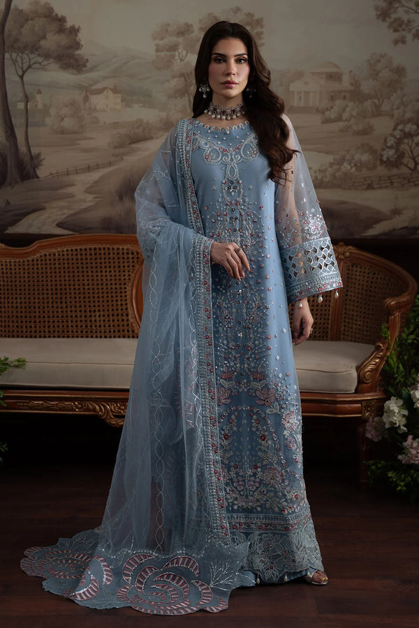 Model sitting in Nureh Elanora Style 74 embellished blue net outfit with embroidered dupatta