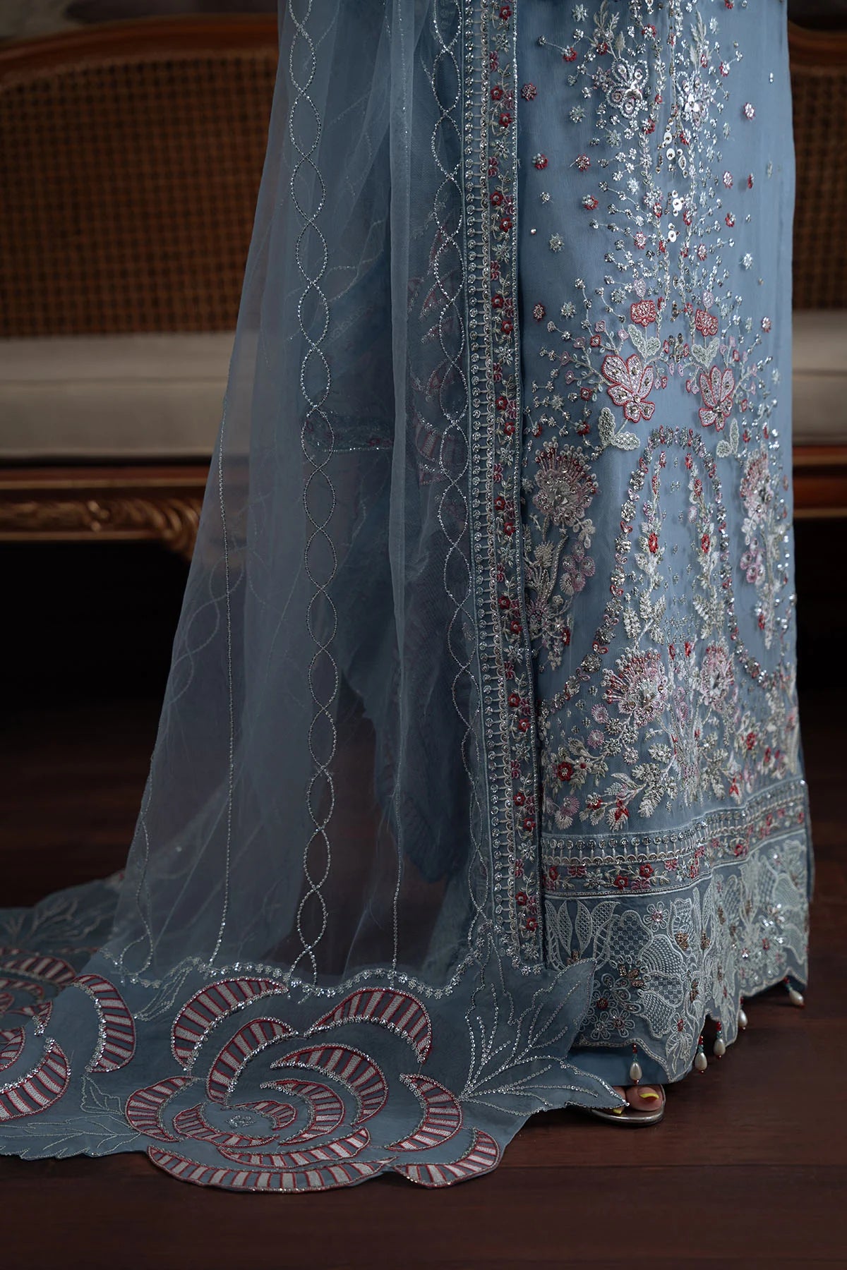 Zoomed-in embroidery on lower front panel and scalloped border of Style 74 outfit