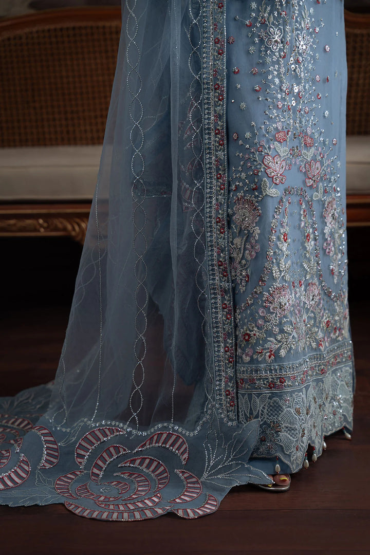 Zoomed-in embroidery on lower front panel and scalloped border of Style 74 outfit