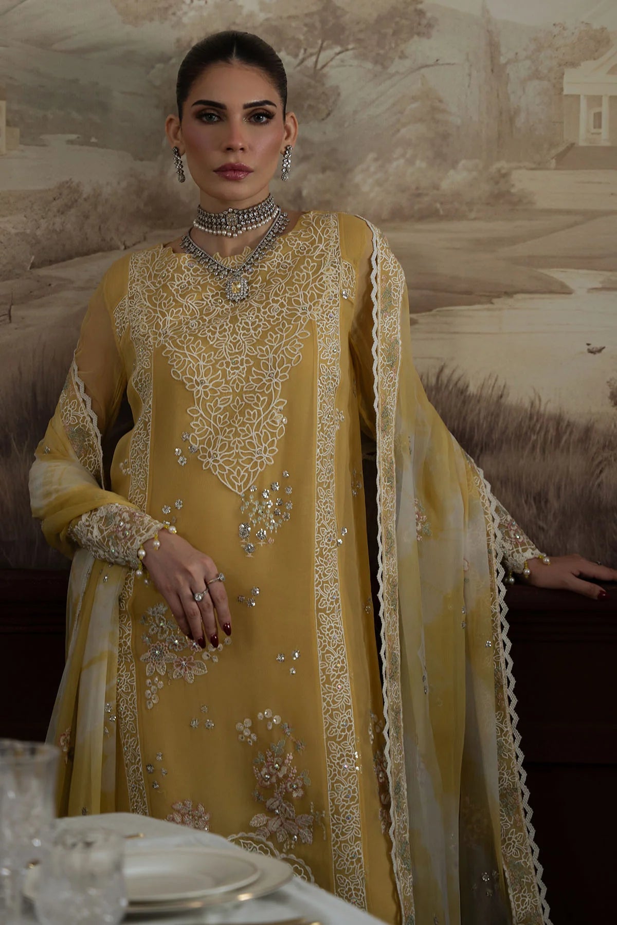 Front view of Nureh Style 76 with intricate white floral embroidery and hand embellishments on mustard chiffon.