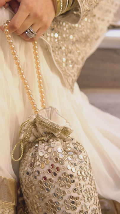 Complete Pakistani wedding trousseau featuring gharara, dupatta, potli clutch, khussa shoes, and jewelry for nikaah events.