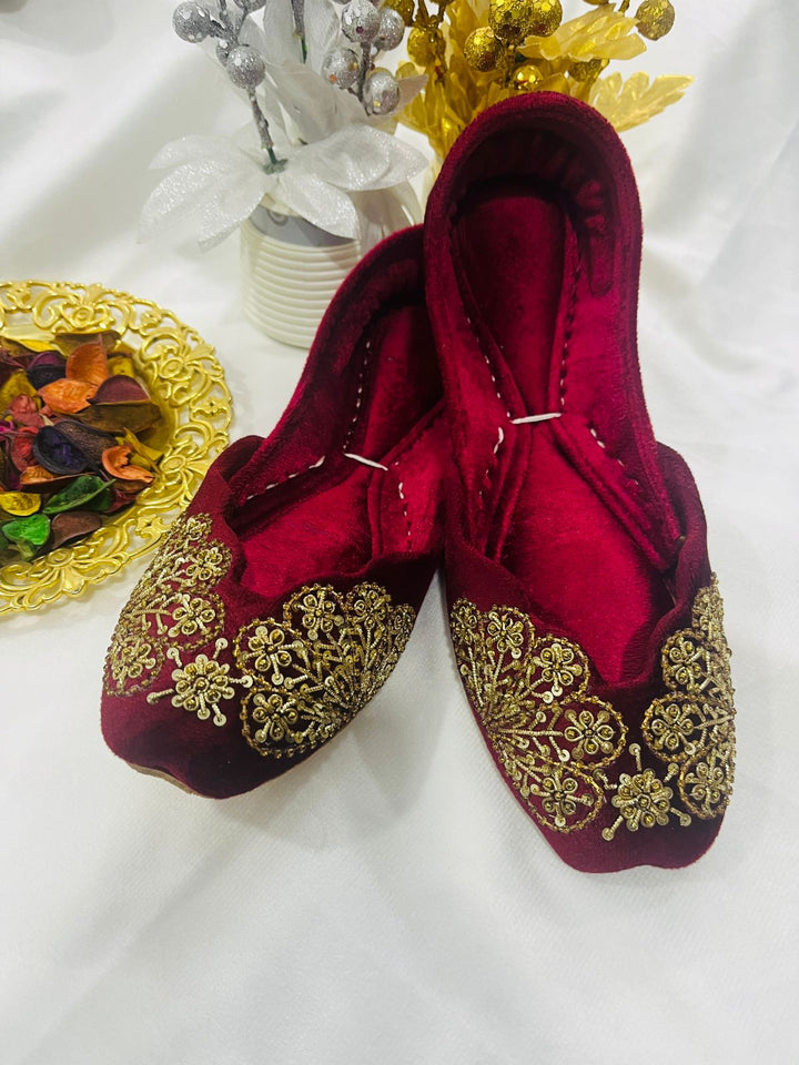 Handcrafted maroon velvet khussas with intricate gold embroidery and cushioned lining – festive women’s footwear